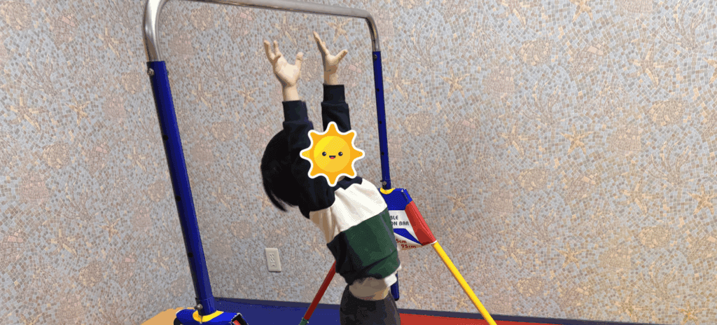室内鉄棒につかまろうとしている息子の様子